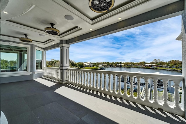 balcony with a water view and ceiling fan