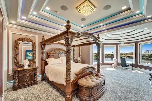 bedroom with carpet floors, ornamental molding, a water view, and a raised ceiling