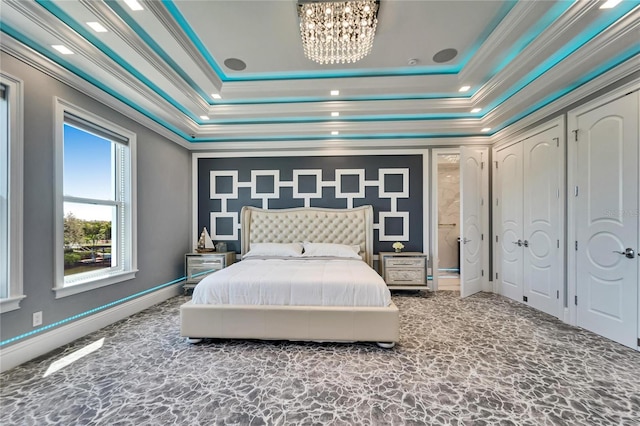 bedroom featuring baseboards, ornamental molding, a raised ceiling, and a chandelier