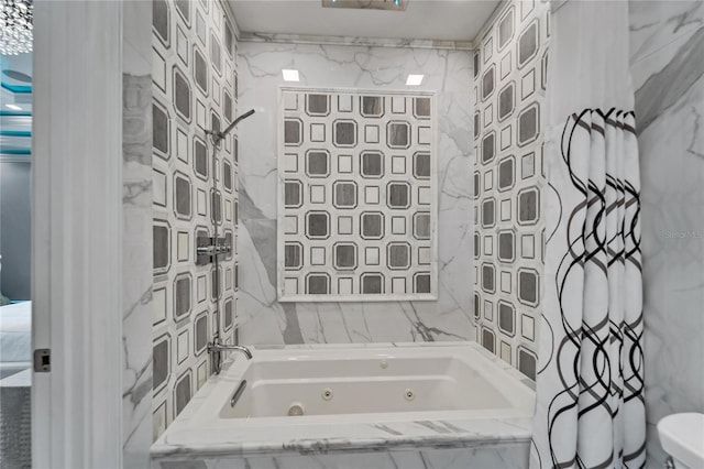 bathroom with toilet, tile walls, and a tub with jets