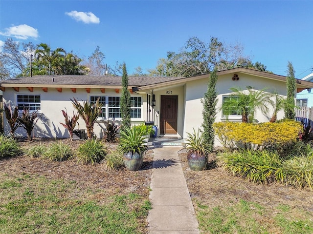 ranch-style home featuring stucco siding