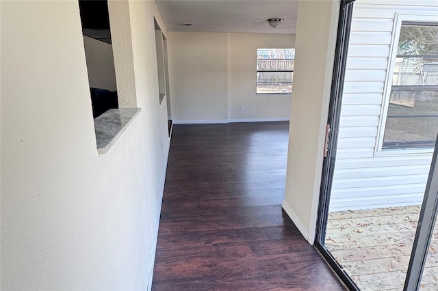 corridor with dark hardwood / wood-style floors