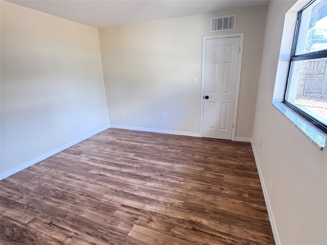 unfurnished room featuring dark hardwood / wood-style floors