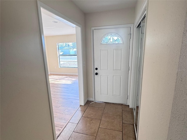 doorway featuring light tile patterned floors