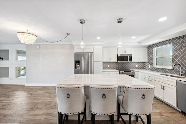 105 4th Ave NE Unit 418, Saint Petersburg, FL 33701 - kitchen with sink, decorative light fixtures, stainless steel appliances, and a kitchen island