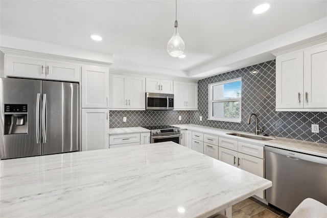 105 4th Ave NE Unit 418, Saint Petersburg, FL 33701 - kitchen with white cabinetry, appliances with stainless steel finishes, sink, and pendant lighting