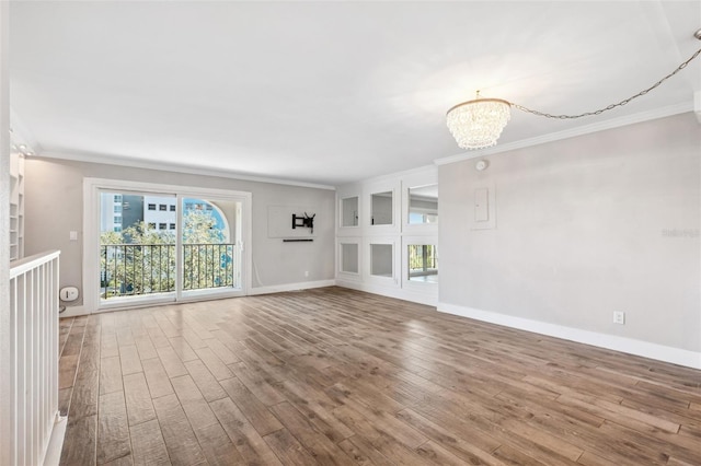 105 4th Ave NE Unit 418, Saint Petersburg, FL 33701 - unfurnished living room featuring crown molding, hardwood / wood-style floors, and a chandelier