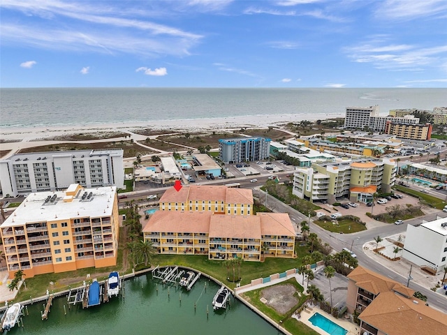 aerial view with a water view, a view of city, and a beach view