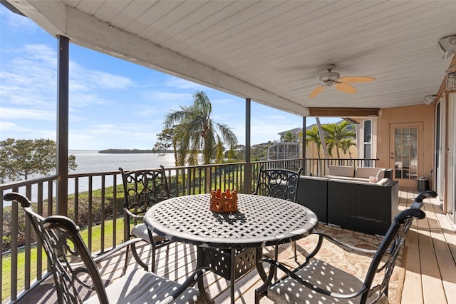 wooden deck featuring an outdoor living space, a water view, outdoor dining space, and a ceiling fan