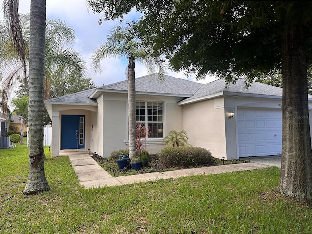 ranch-style home with a front yard and a garage