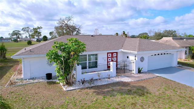 ranch-style home featuring a fenced front yard, a shingled roof, concrete driveway, a gate, and a garage