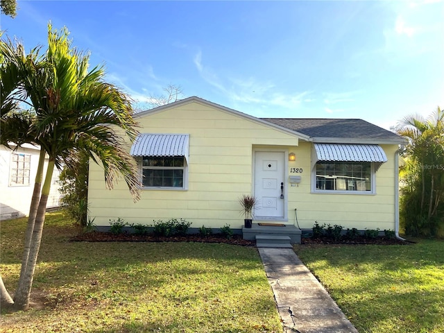 bungalow-style house featuring a front yard