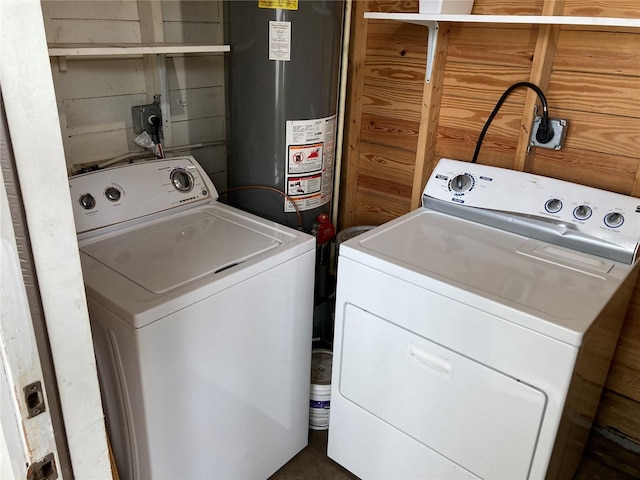 washroom with washing machine and dryer and gas water heater