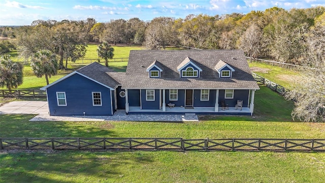 view of front of property with a fenced backyard, a shingled roof, and a front lawn