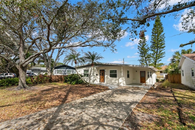 single story home featuring fence