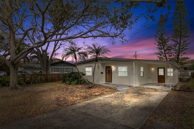 view of front of property featuring driveway and fence