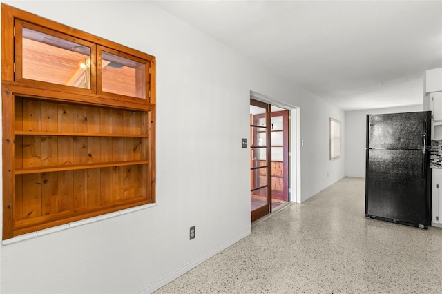 unfurnished room with light speckled floor