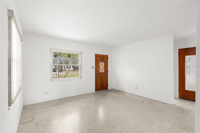 unfurnished room with light speckled floor