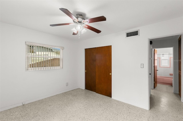 unfurnished bedroom featuring baseboards, visible vents, a closet, and speckled floor