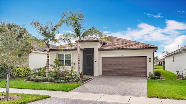 view of front of property with a front lawn, stucco siding, an attached garage, decorative driveway, and a tile roof