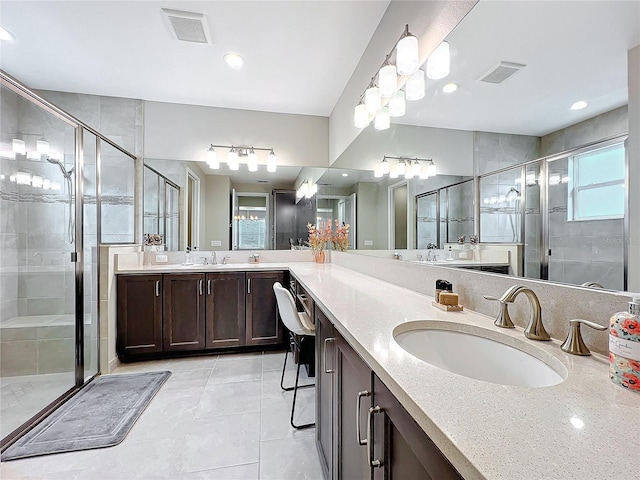 bathroom with a shower stall, visible vents, and a sink