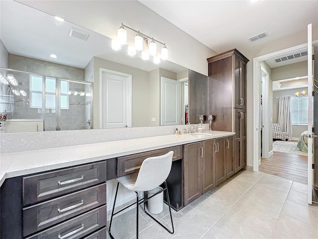 ensuite bathroom with visible vents, tile patterned floors, vanity, and a shower stall