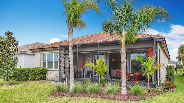 view of front of house featuring a tile roof and a front lawn