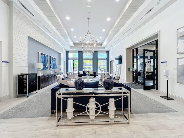 interior space featuring a raised ceiling, french doors, recessed lighting, wood finish floors, and a notable chandelier