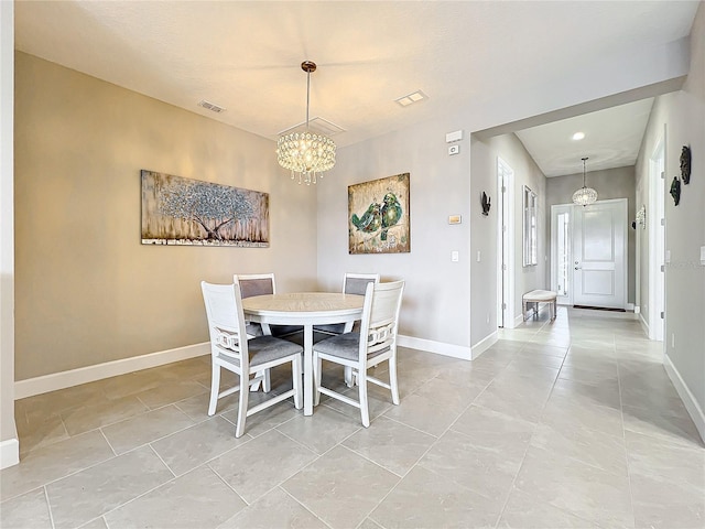 dining area with baseboards, a notable chandelier, and visible vents