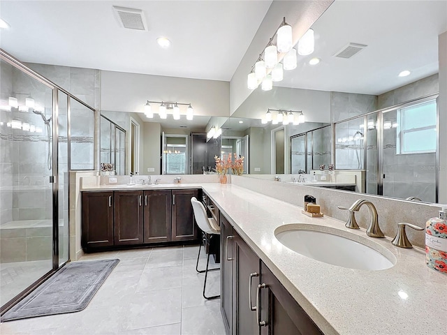 bathroom with vanity, tile patterned flooring, visible vents, and a stall shower