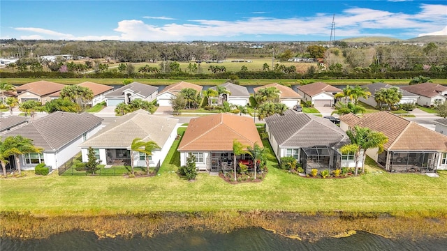birds eye view of property with a residential view and a water view