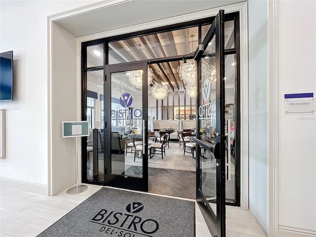 doorway to outside featuring an inviting chandelier and french doors
