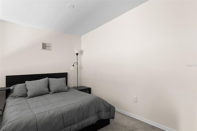 carpeted bedroom featuring a textured ceiling