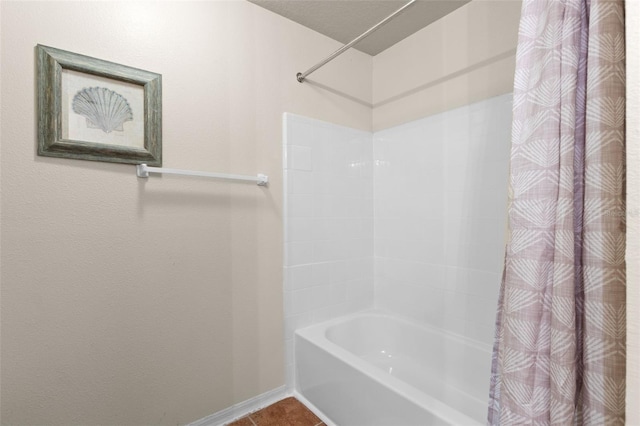 bathroom with shower / tub combo with curtain and tile patterned flooring