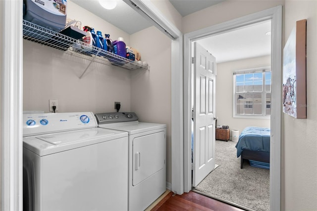 laundry room with dark hardwood / wood-style flooring and washing machine and clothes dryer