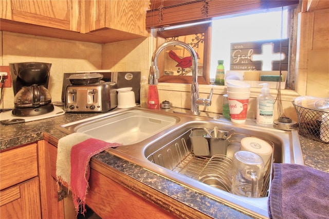 interior details featuring sink and decorative backsplash