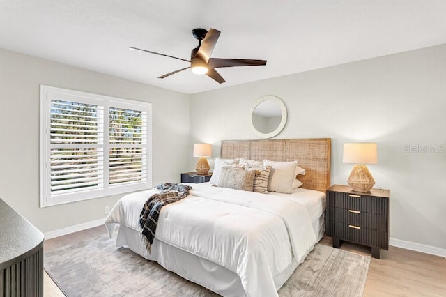 bedroom featuring ceiling fan and light hardwood / wood-style floors