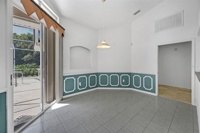 empty room with visible vents and dark tile patterned floors