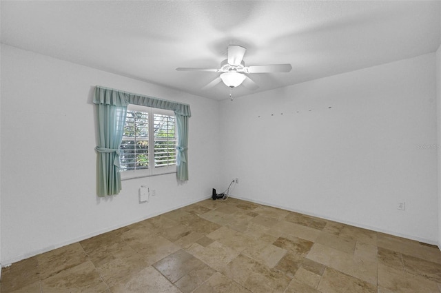 spare room featuring a ceiling fan