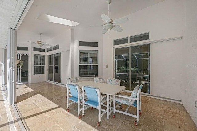 view of patio with outdoor dining space and a ceiling fan