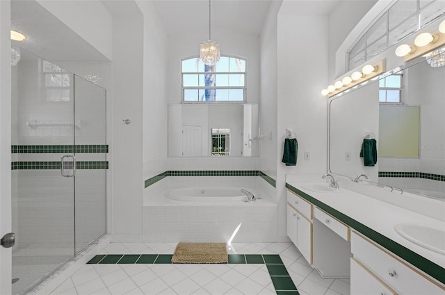 bathroom featuring a healthy amount of sunlight, tile patterned floors, a sink, and a bath