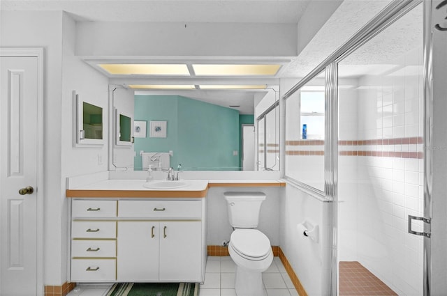 full bath with toilet, a shower stall, vanity, and tile patterned floors