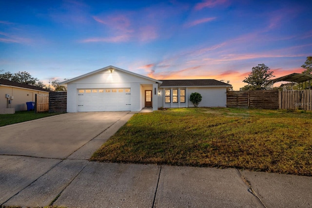 ranch-style house with a garage and a lawn