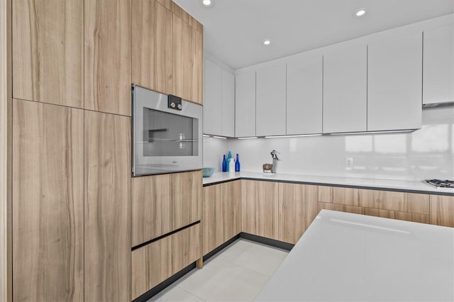 kitchen with white cabinetry and stainless steel oven