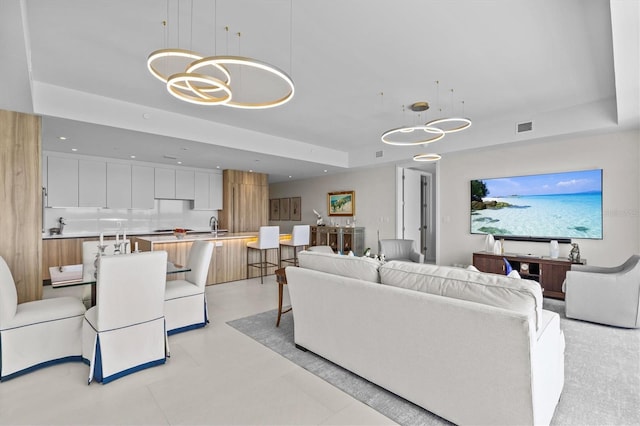 living room with sink and a chandelier