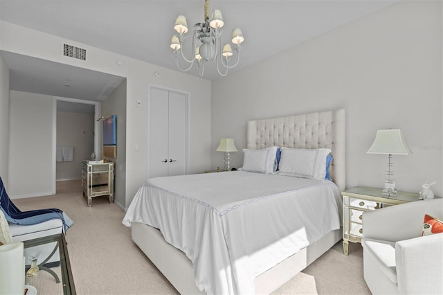 bedroom with carpet floors, a closet, and a chandelier