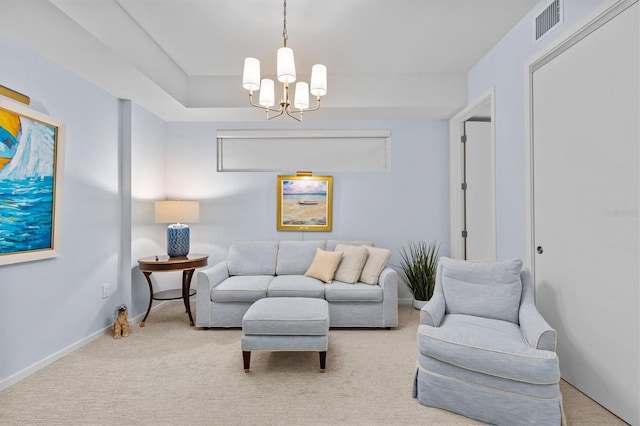 carpeted living room featuring a notable chandelier