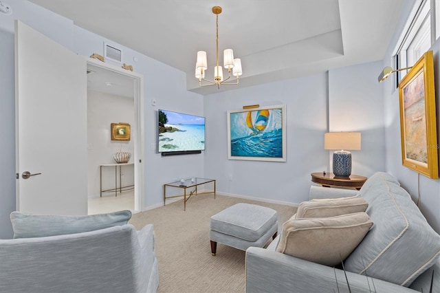 carpeted living room featuring a notable chandelier