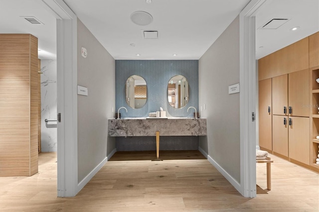 bathroom with hardwood / wood-style flooring and vanity