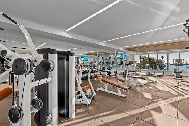 exercise room with a water view